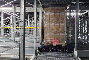 Moffett Automation system in action, showing an automated guided vehicle handling cargo in a warehouse setup